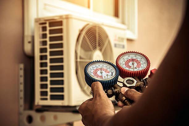 Professional Air Conditioning Service technician working in Farley, MO